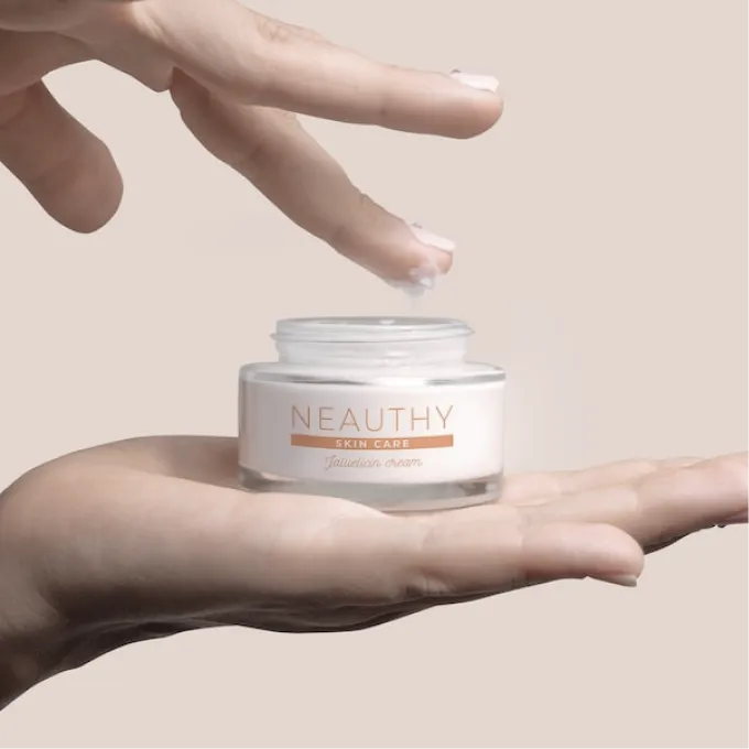 holding a jar of cream