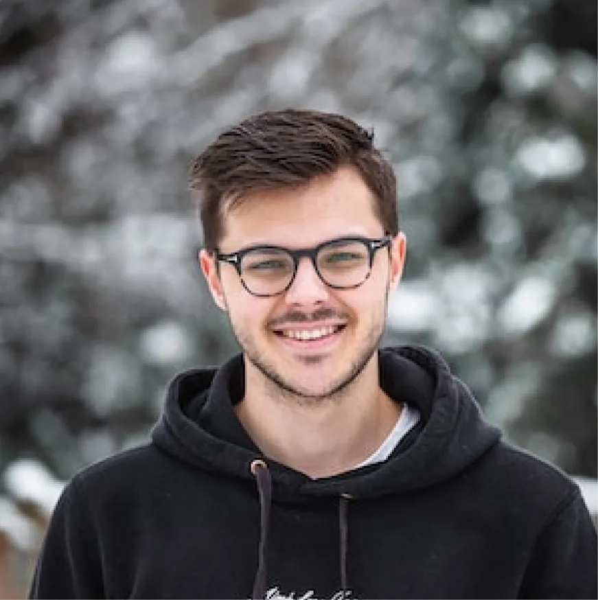 smiling guy with short hair and glasses