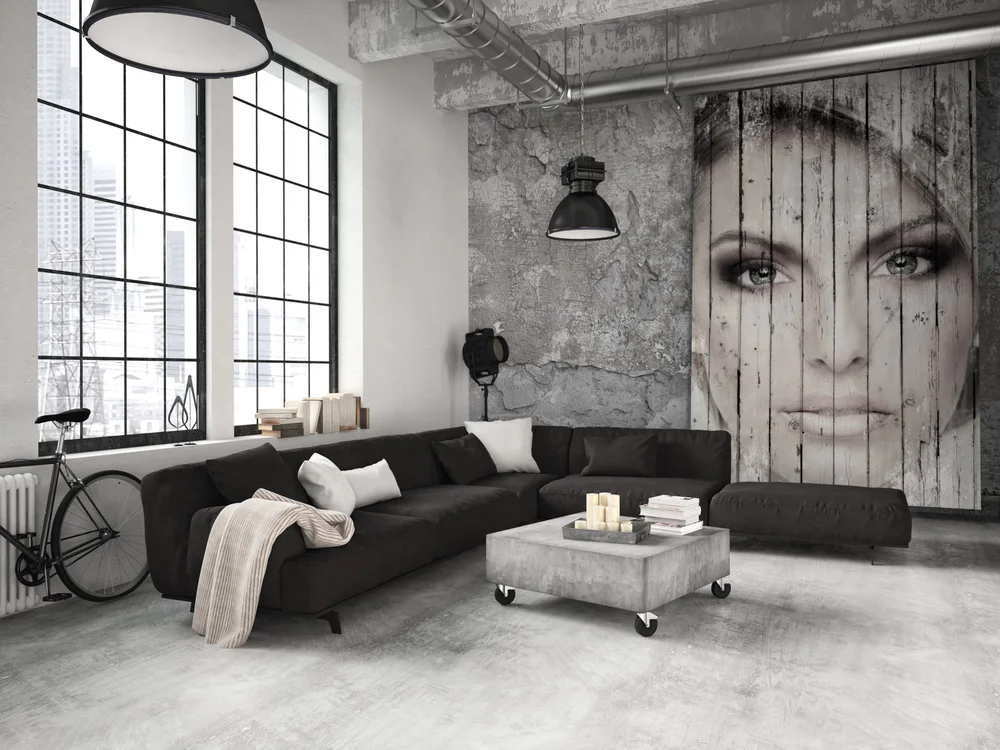 gray room with black and white furniture, and a huge painting of a girl
