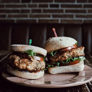 Two sandwiches with lettuce and tomato on a plate