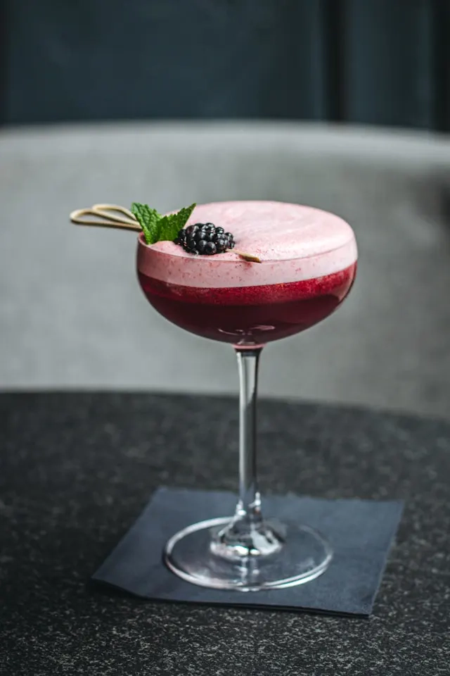 Red drink in a glass with a tall stem