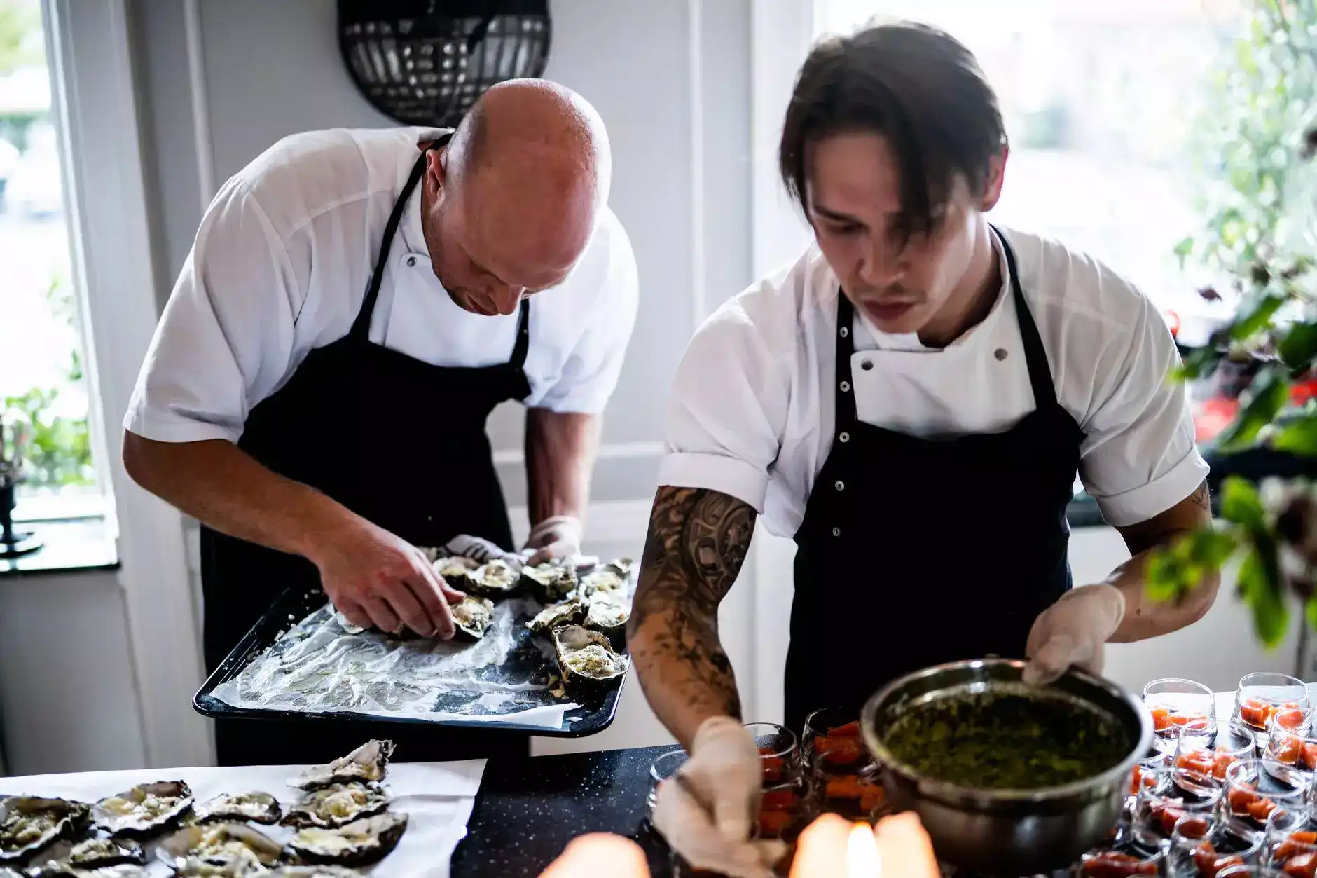 two men cooking dishes