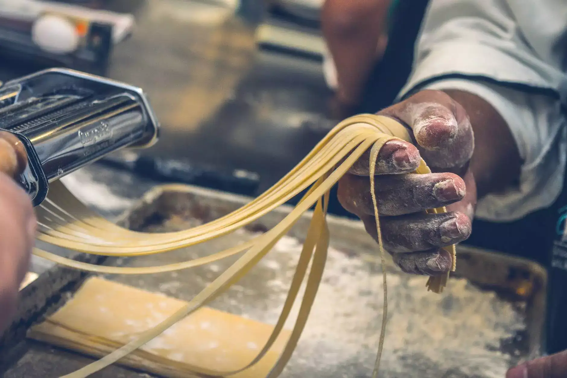 cook holds in the hands of the pasta