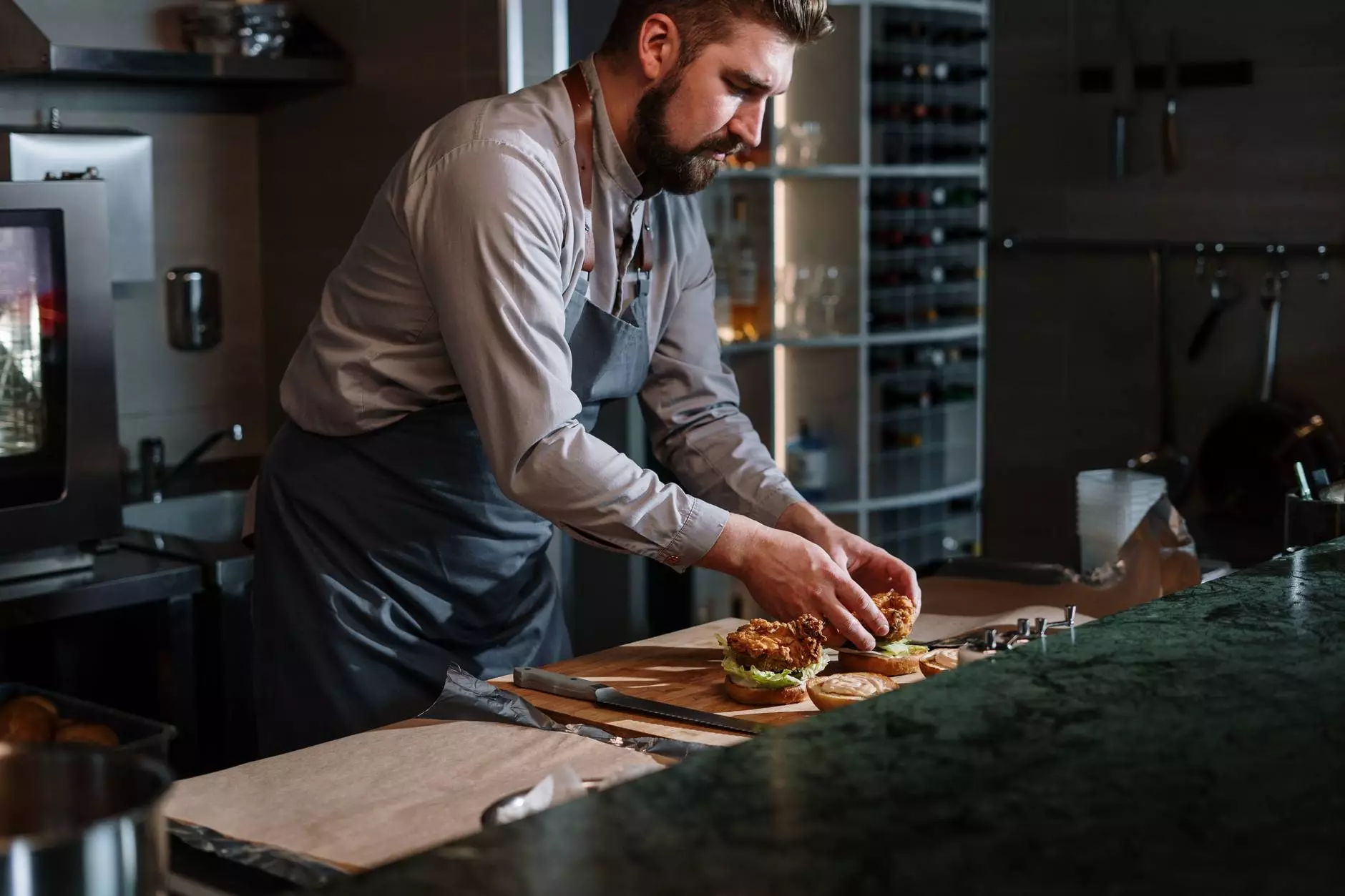 the cook prepares a burger
