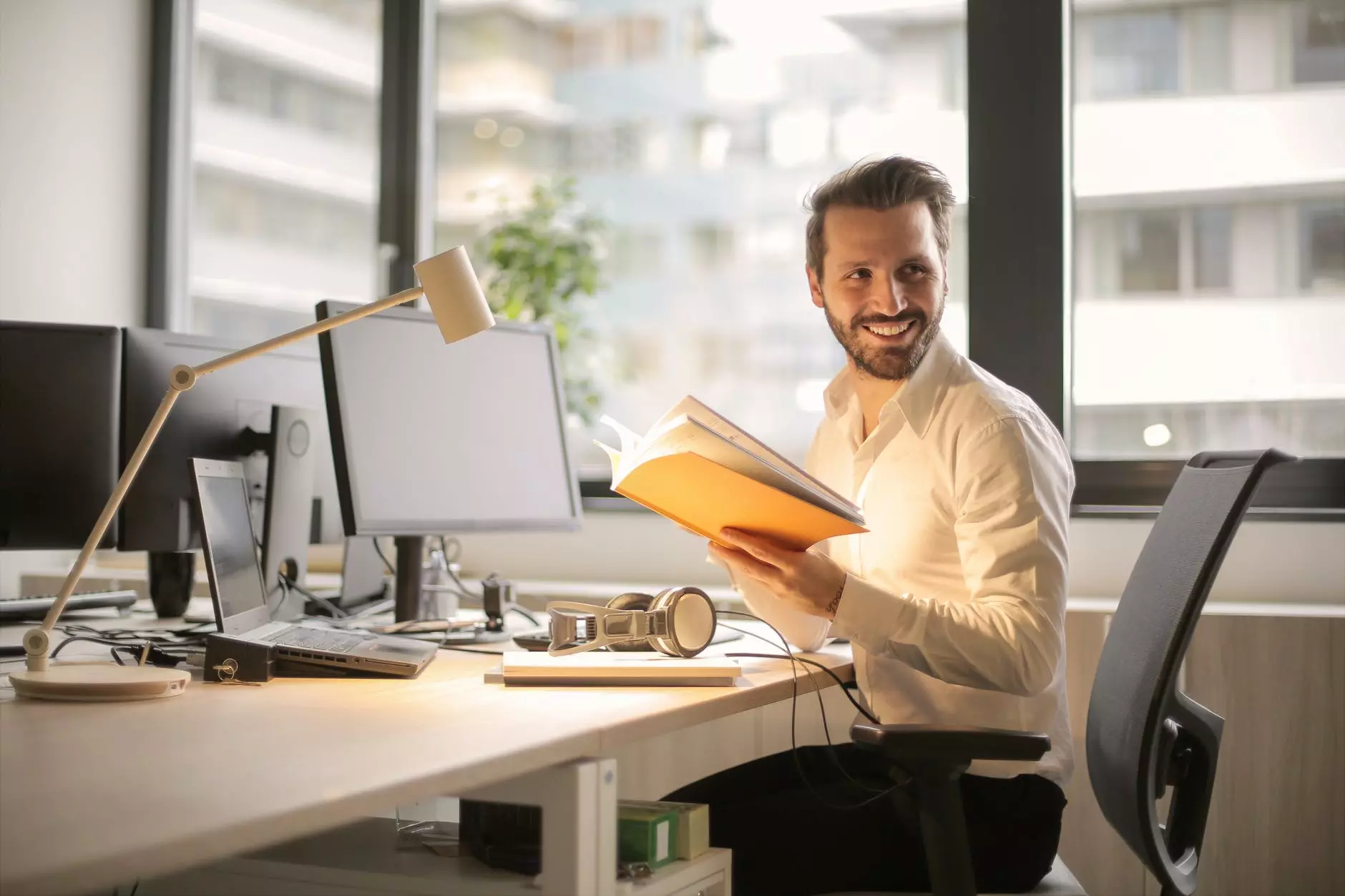 a man in a white shirt with a book in his hands