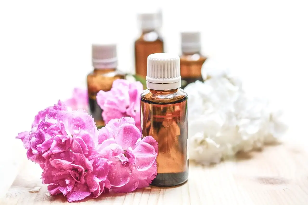 small glass bottles and flowers nearby