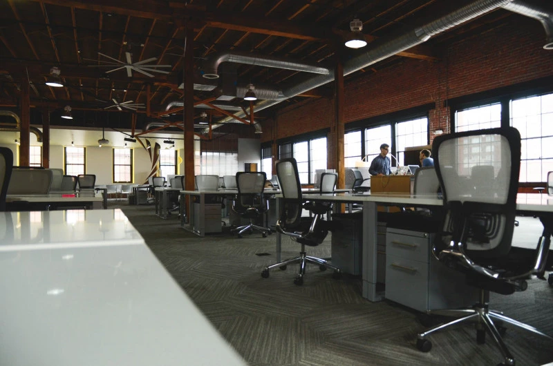 a large room with many desks and chairs
