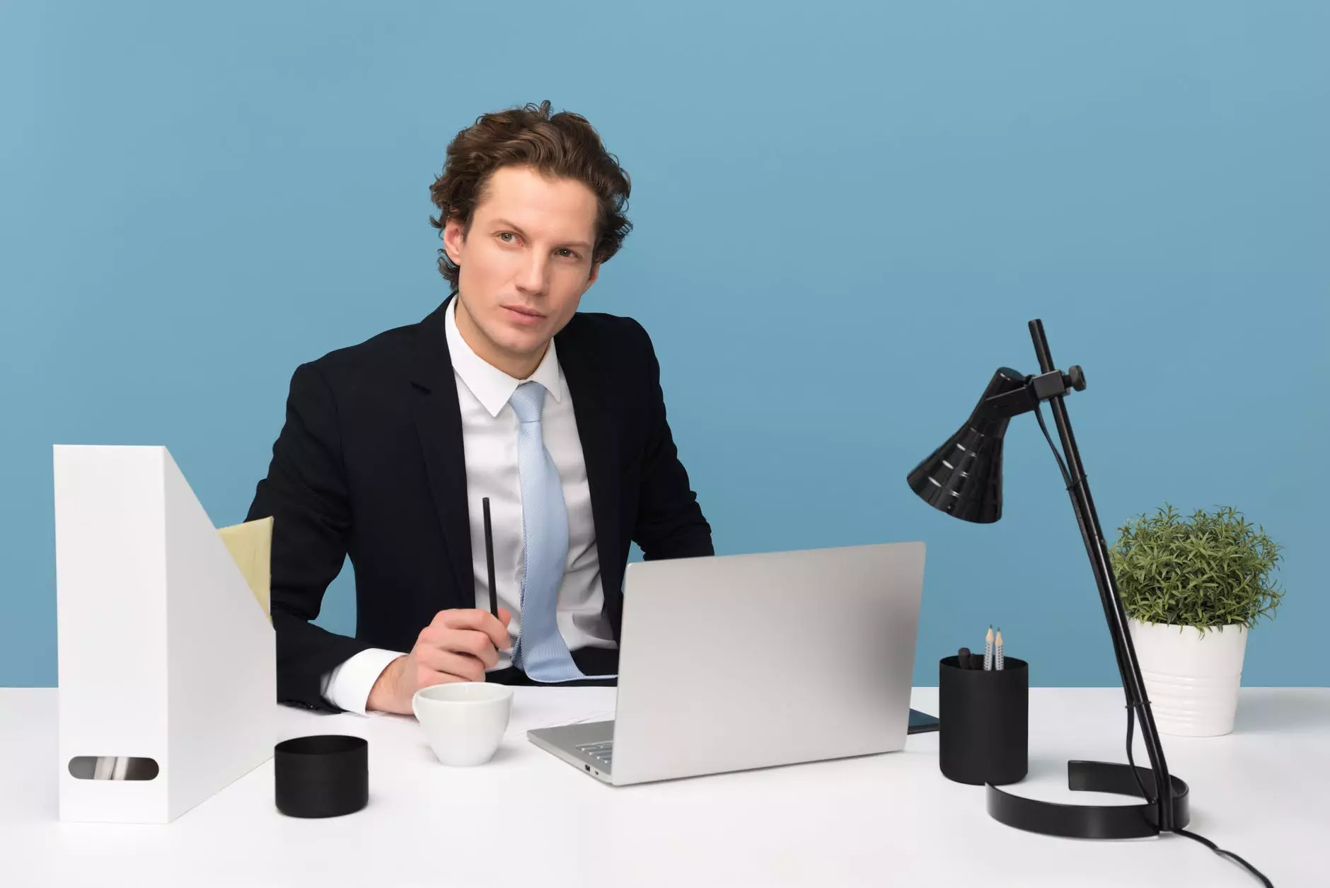 a man in a suit sits at a table