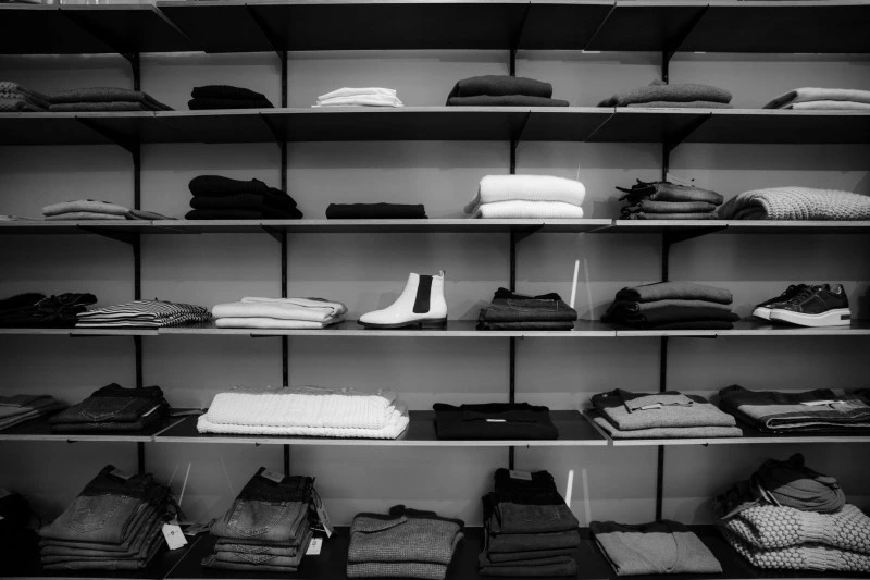 shelves with clothes and shoes on them