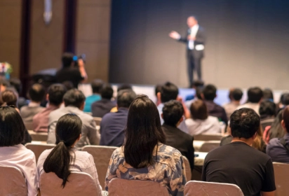 a conference room fully filled with attendees