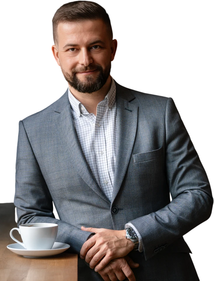 Mężczyzna w garniturze siedzi na krześle i odwraca wzrok