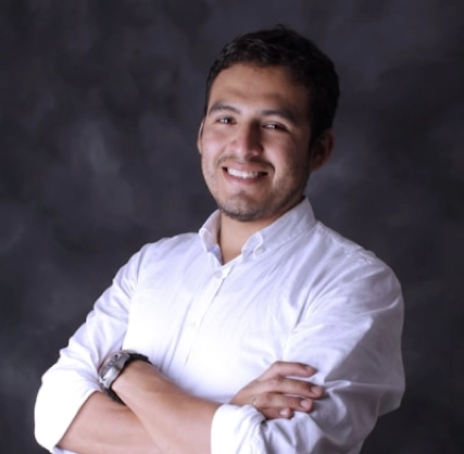 A young man with a smile on his face